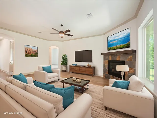 a living room with furniture a fireplace and a flat screen tv
