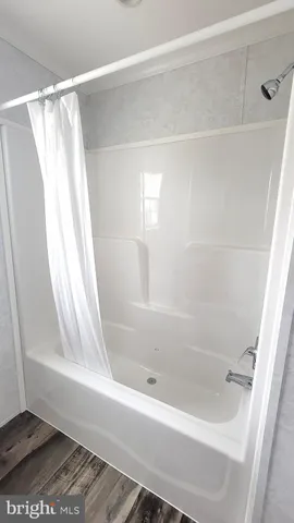 a bathroom with a bathtub and a shower