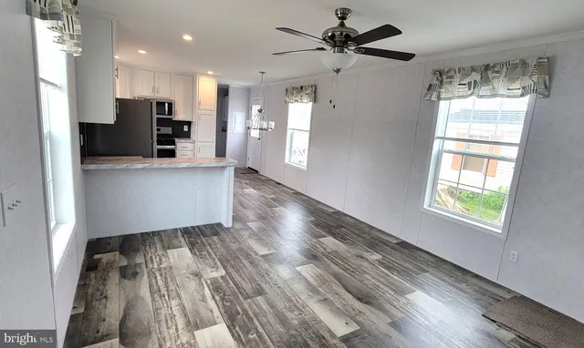 a view of kitchen with stainless steel appliances refrigerator oven and cabinets