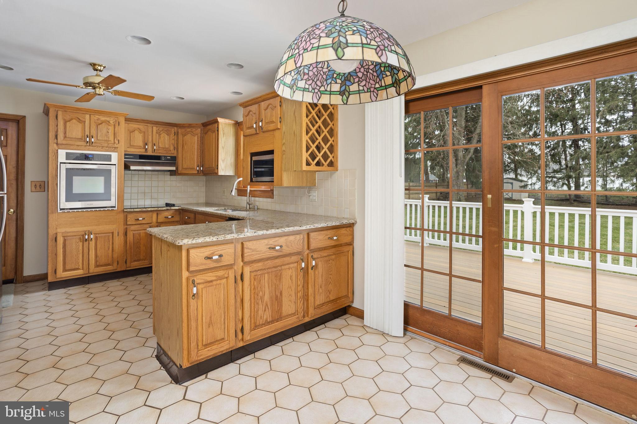 96 Bordentown Chesterfield Road Chesterfield, NJ 08515 - Photo 10 of 42 a kitchen with stainless steel appliances granite countertop a stove a sink and a chandelier