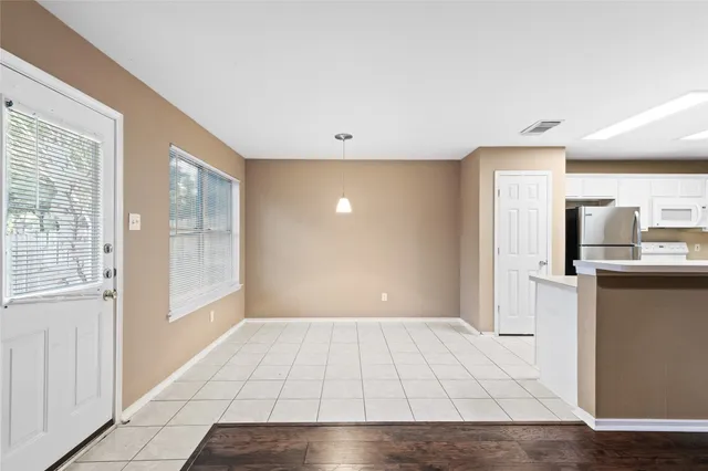 a view of a kitchen with an empty space and a window