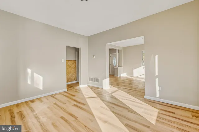 a view of a room with wooden floor and a bathroom