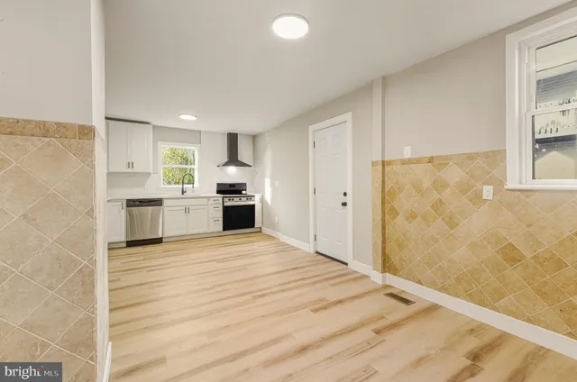 a view of a kitchen with a sink and a refrigerator