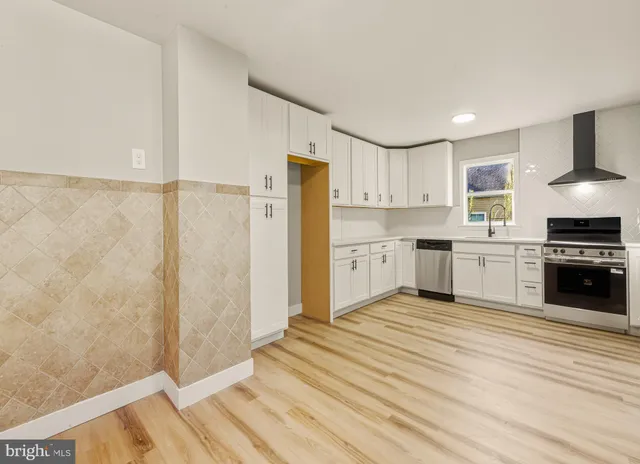 a kitchen with stainless steel appliances a refrigerator and a stove top oven