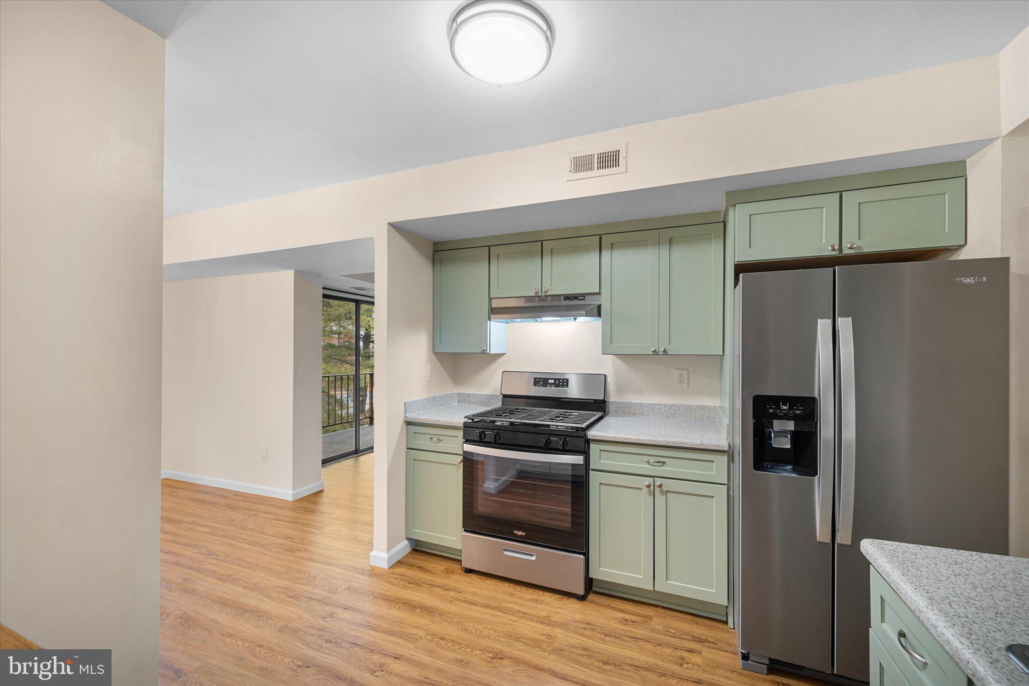 2073 Royal Fern Court, Unit 34/21B Reston, VA 20191 - Photo 10 of 25 a kitchen with stainless steel appliances a refrigerator and a stove top oven