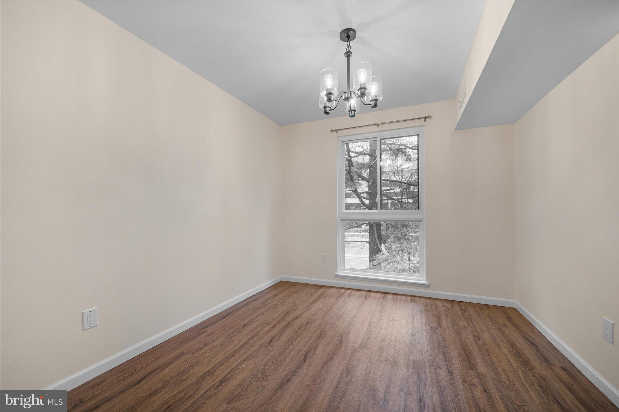 2073 Royal Fern Court, Unit 34/21B Reston, VA 20191 - Photo 13 of 25 a view of an empty room with wooden floor and a window