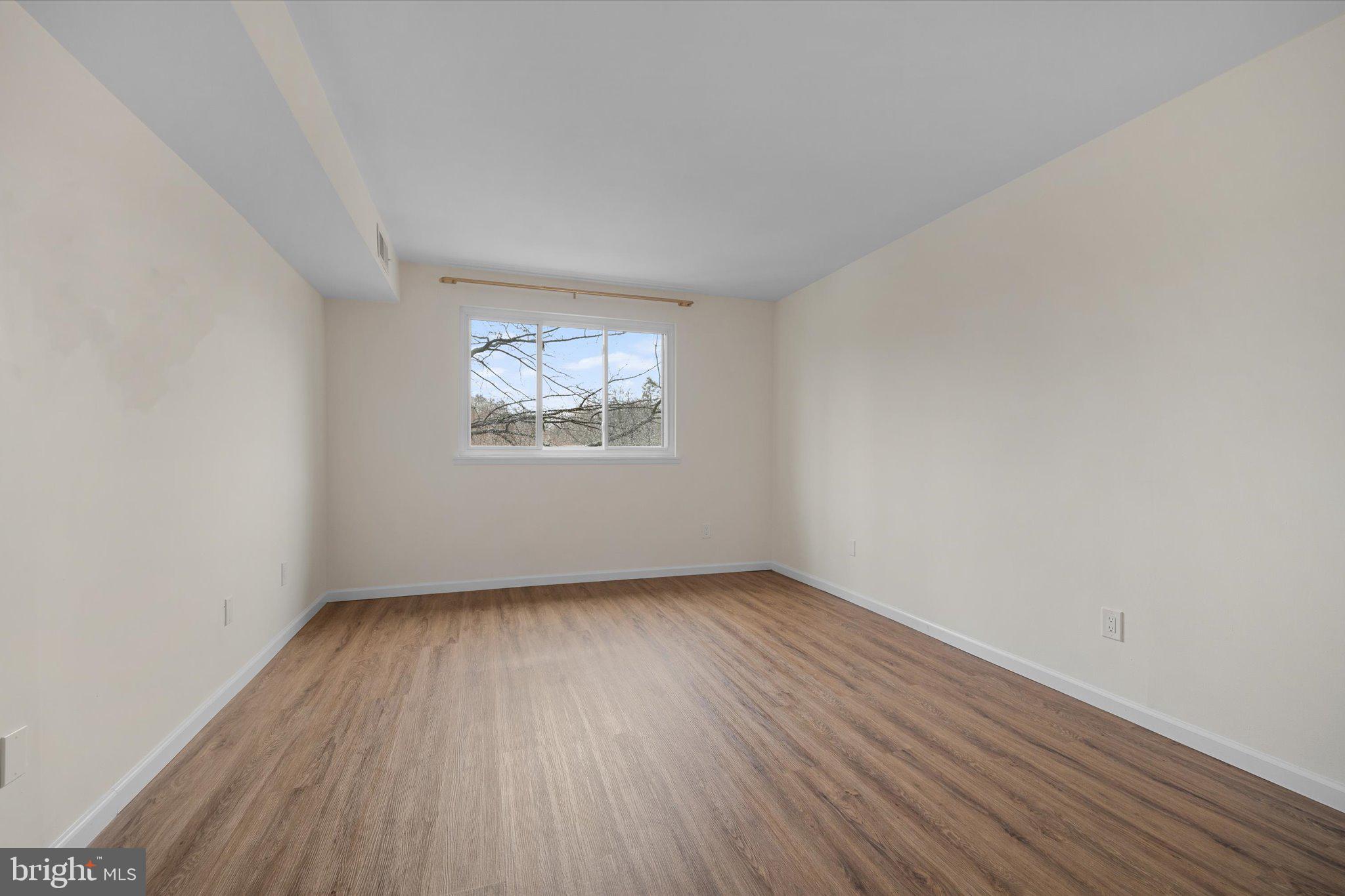 2073 Royal Fern Court, Unit 34/21B Reston, VA 20191 - Photo 15 of 25 an empty room with wooden floor and windows