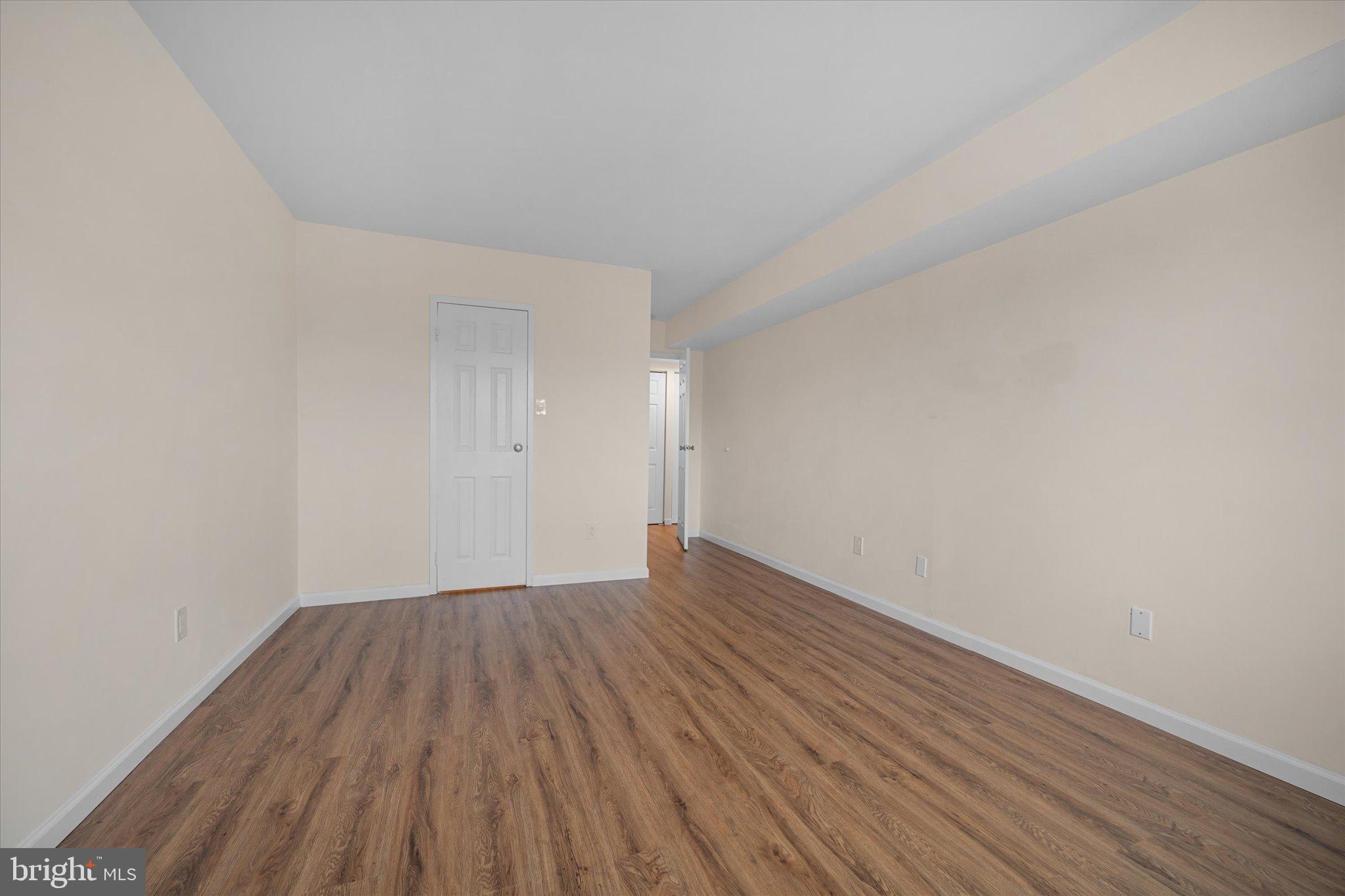 2073 Royal Fern Court, Unit 34/21B Reston, VA 20191 - Photo 16 of 25 a view of an empty room with wooden floor
