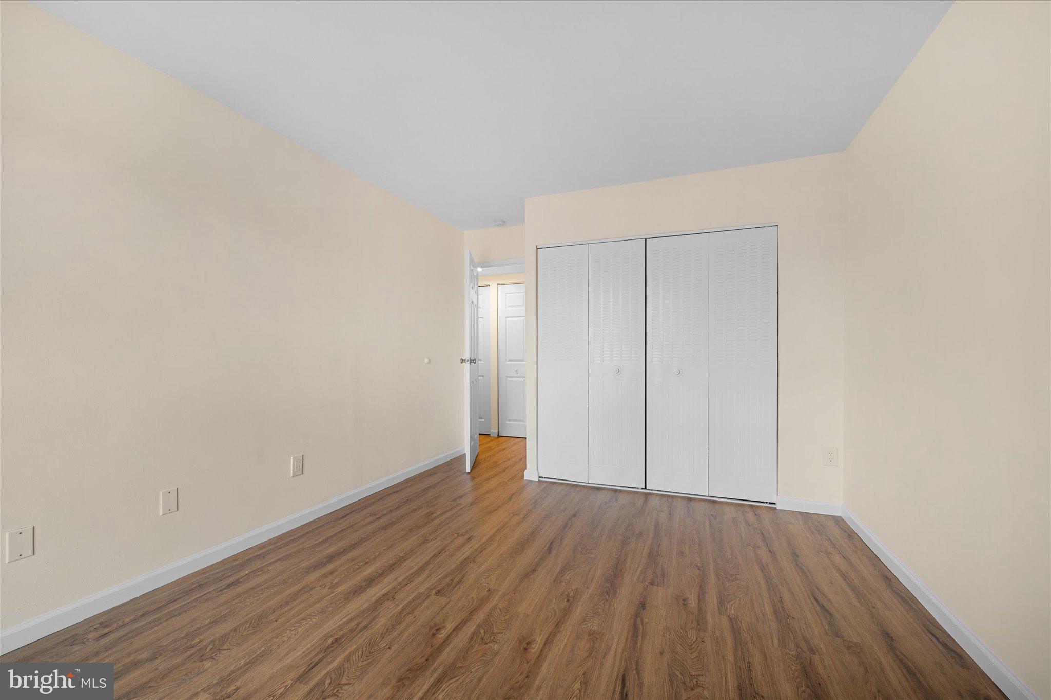 2073 Royal Fern Court, Unit 34/21B Reston, VA 20191 - Photo 19 of 25 a view of an empty room with wooden floor