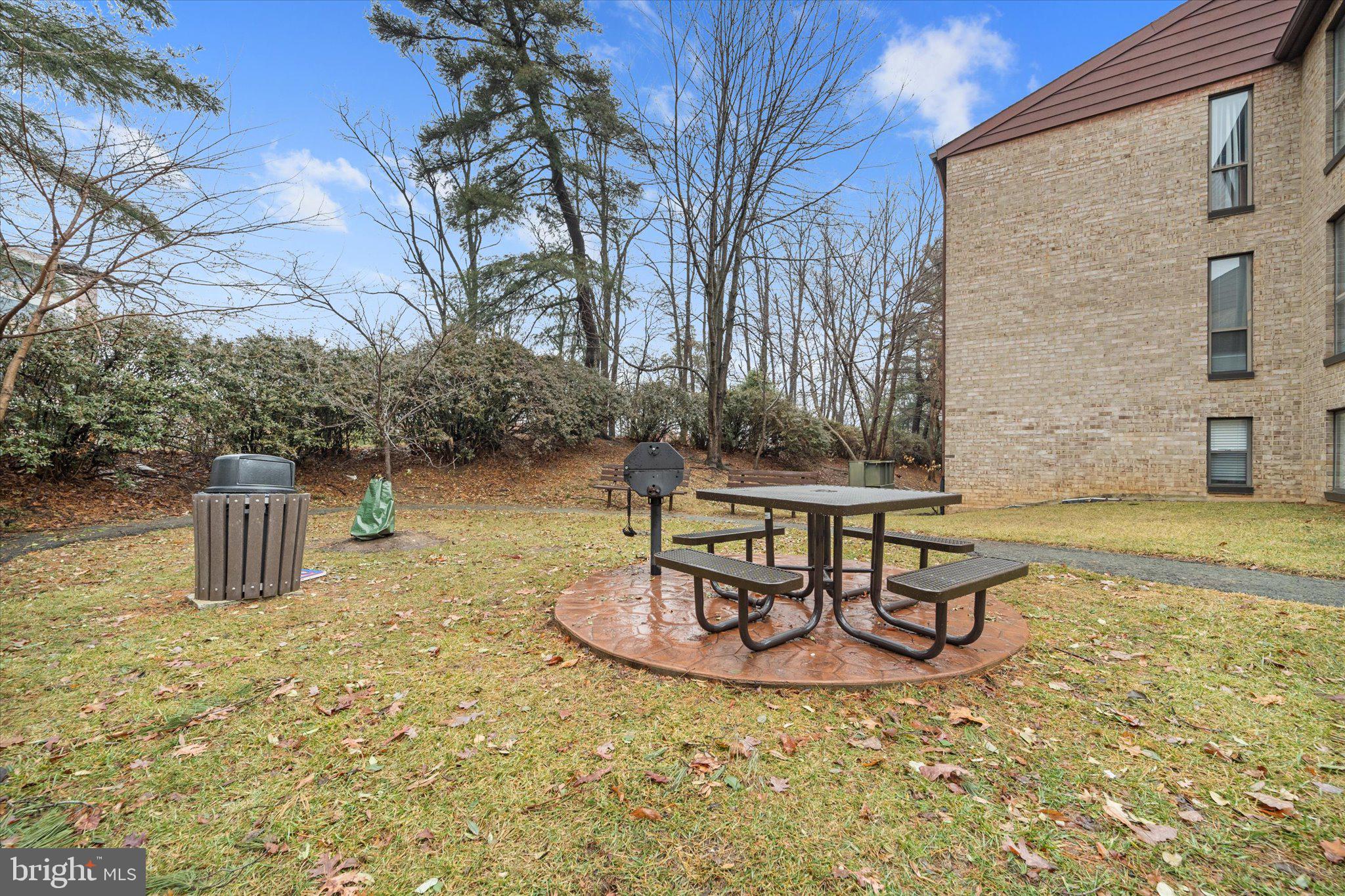 2073 Royal Fern Court, Unit 34/21B Reston, VA 20191 - Photo 24 of 25 a table and chairs sitting in the backyard of a house