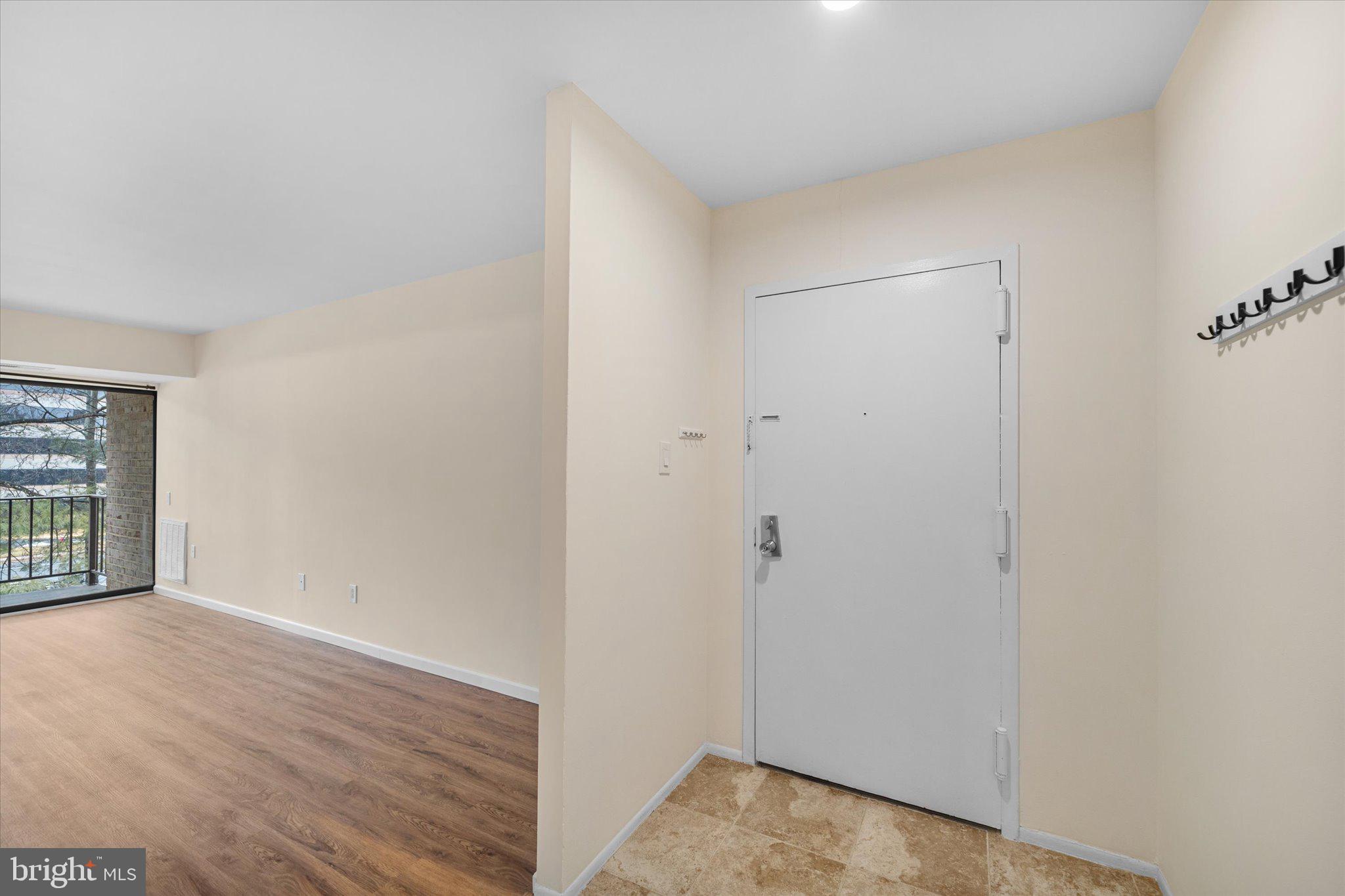 2073 Royal Fern Court, Unit 34/21B Reston, VA 20191 - Photo 5 of 25 a view of an empty room with wooden floor and a window