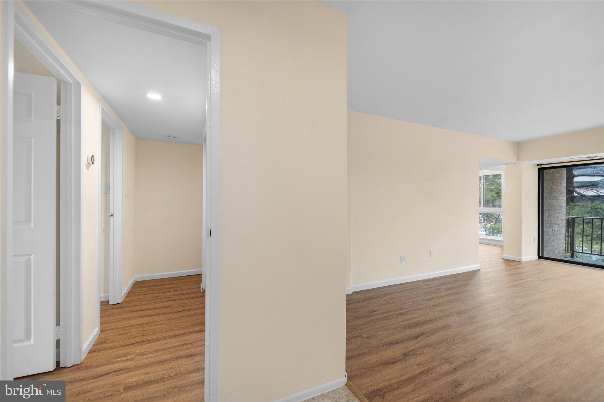 2073 Royal Fern Court, Unit 34/21B Reston, VA 20191 - Photo 25 of 25 a view of an empty room with wooden floor and a window