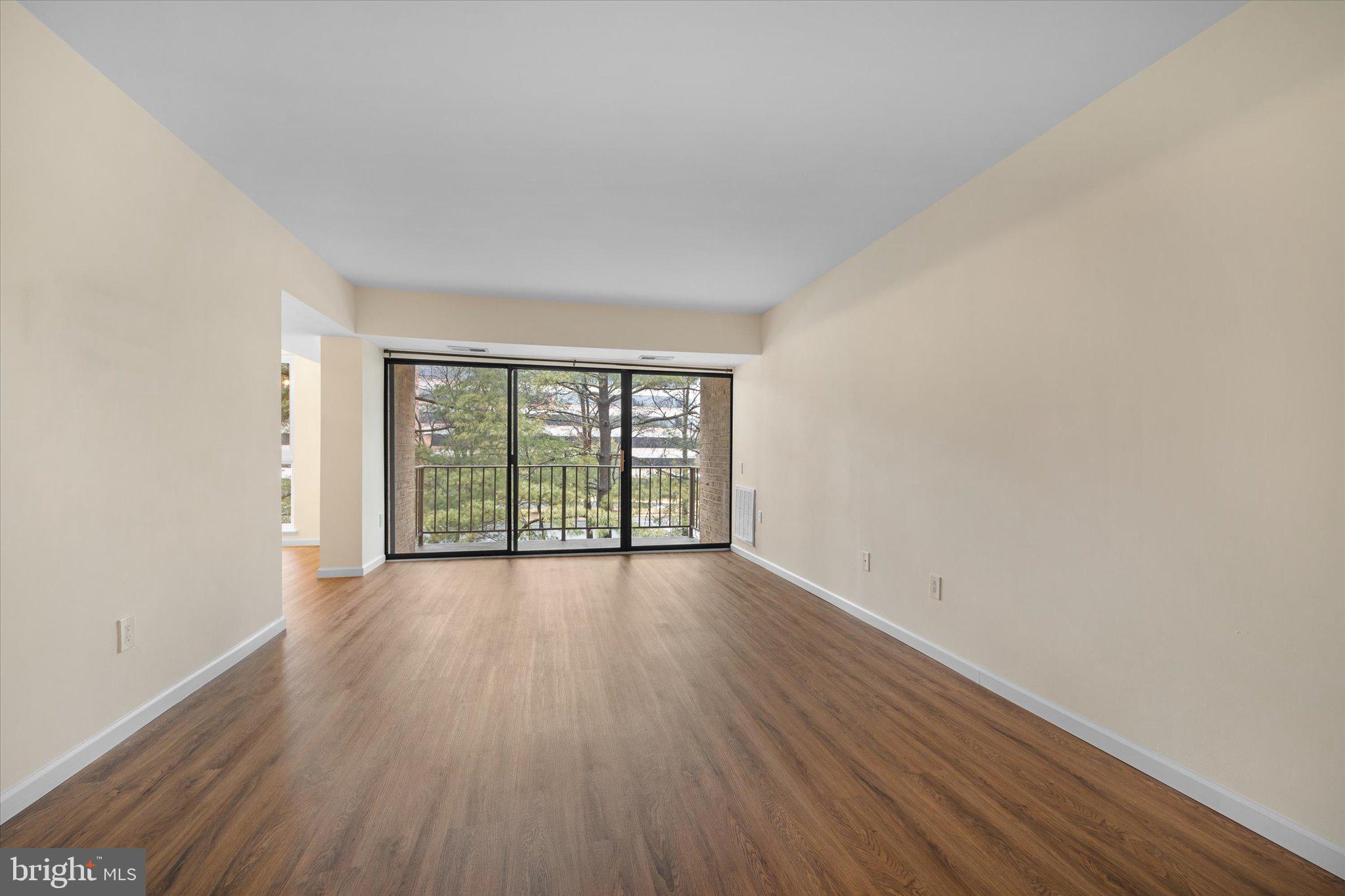 2073 Royal Fern Court, Unit 34/21B Reston, VA 20191 - Photo 6 of 25 wooden floor in an empty room with a window