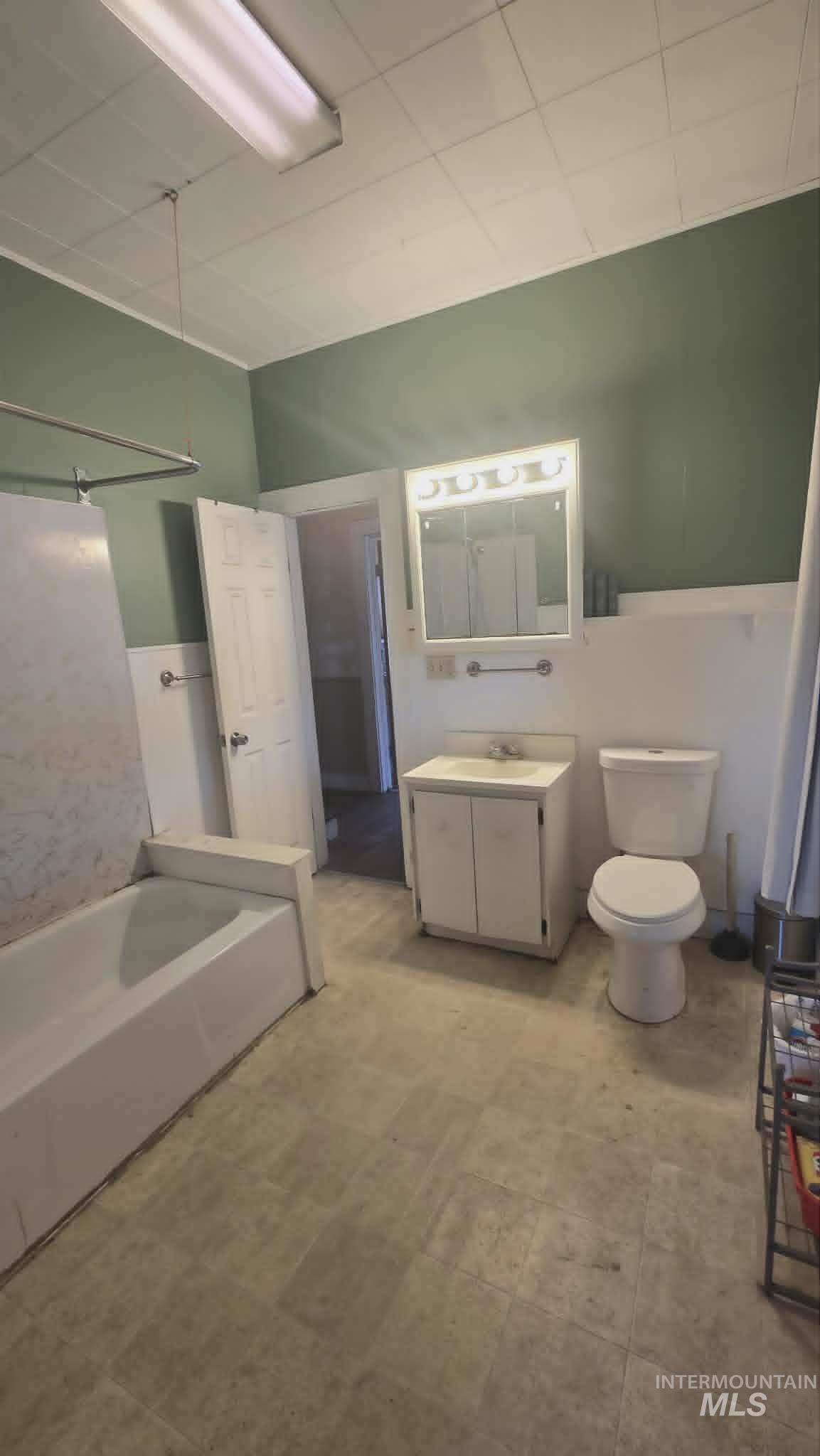 1212 Main Street Pomeroy, WA 99347 - Photo 13 of 18 Bathroom featuring a full vanity with integrated sink, white toilet, and a bathtub with shower