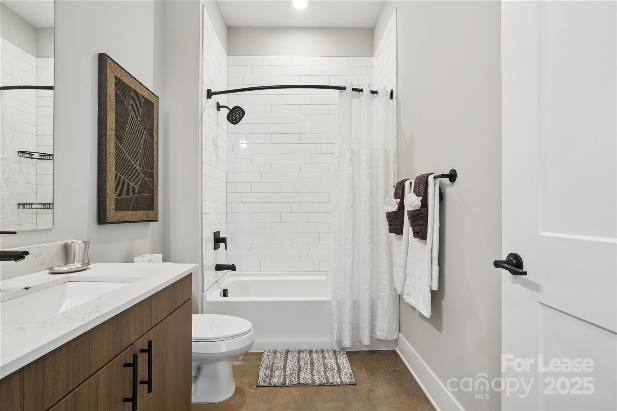 110 Razades Way, Unit A1 Charlotte, NC 28206 - Photo 23 of 29 a bathroom with a granite countertop sink a toilet and shower