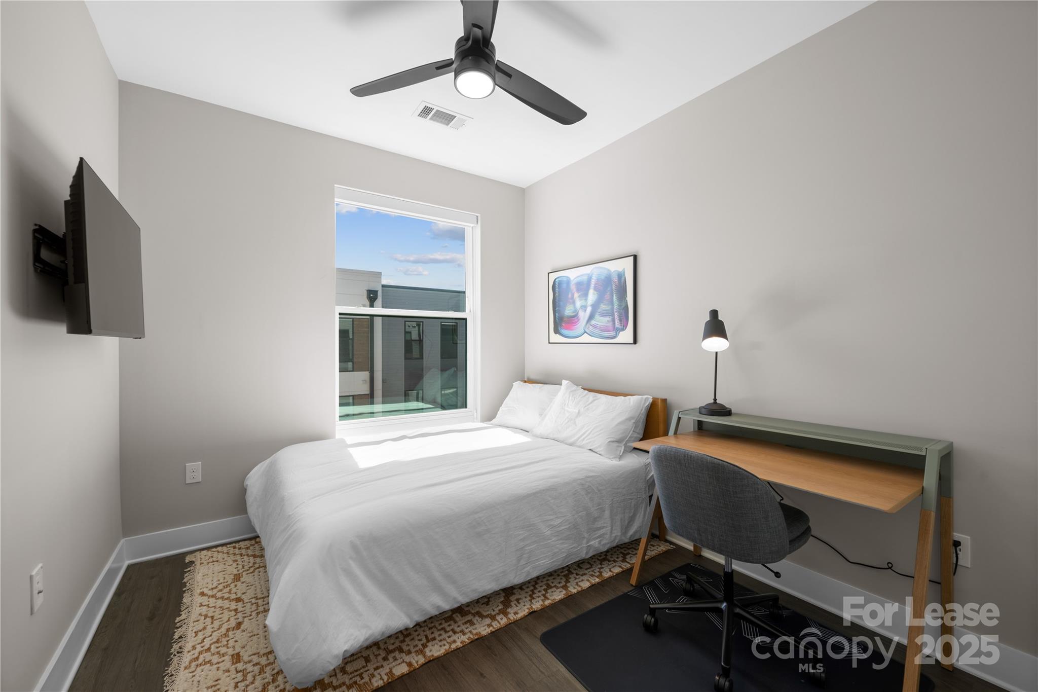 110 Razades Way, Unit A1 Charlotte, NC 28206 - Photo 28 of 29 a bedroom with a bed and a flat screen tv