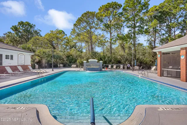 a front view of a house with a garden and sitting area