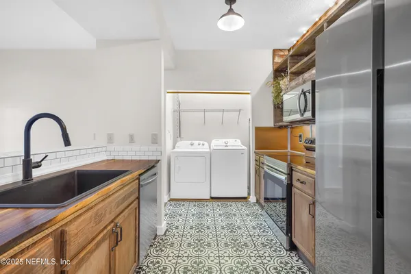 a kitchen with a sink cabinets and stainless steel appliances