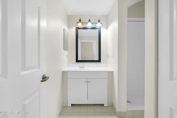 a bathroom with a sink and a mirror