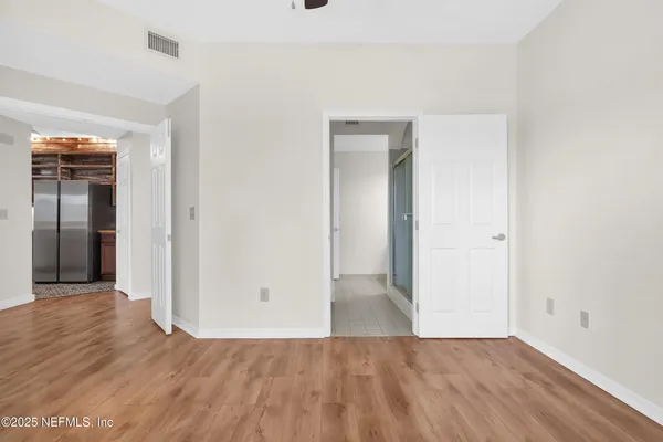 wooden floor in a hall with an empty room