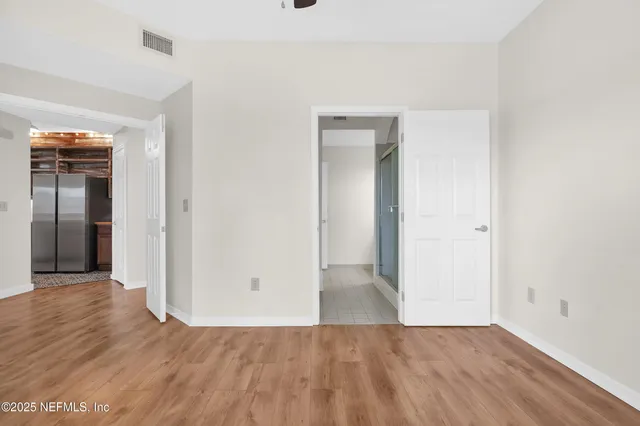 wooden floor in a hall with an empty room