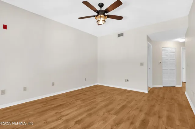 a view of a room with a ceiling fan