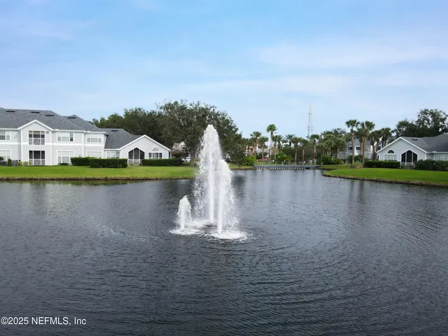 a view of a lake with houses in the background