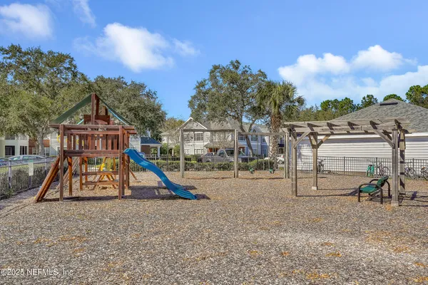 a view of a park with swings and slides