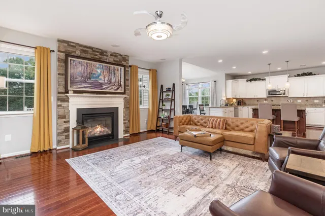 an open kitchen with granite countertop kitchen island wooden cabinets and white appliances