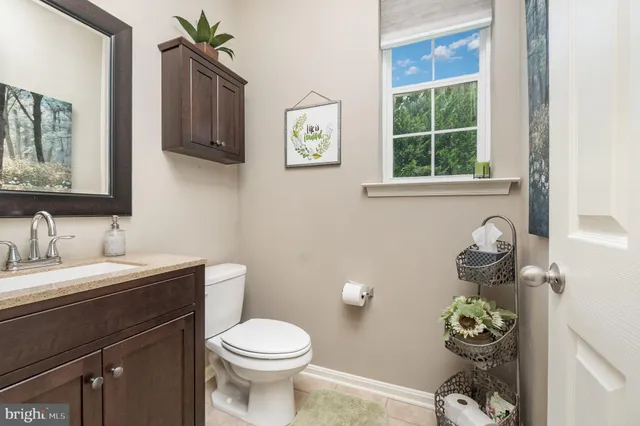 a white toilet sitting next to a bathroom sink