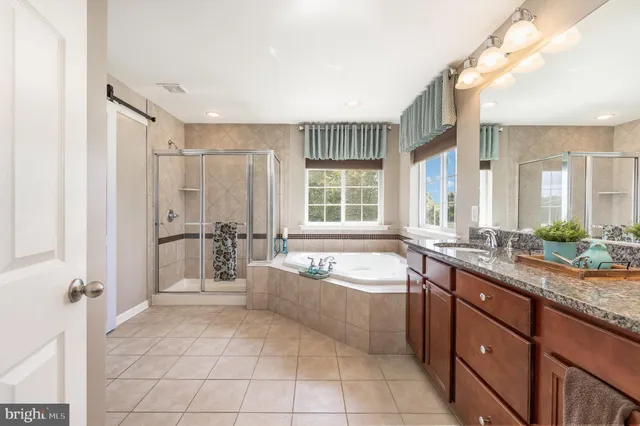 a bedroom with a bed lamp and a window