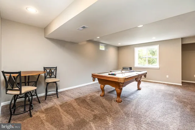 a view of a swimming pool with a patio and a yard