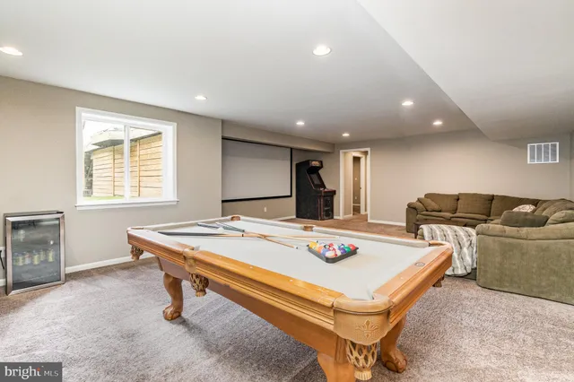 swimming pool view with a seating space