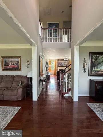 a view of a livingroom with furniture and hardwood floor