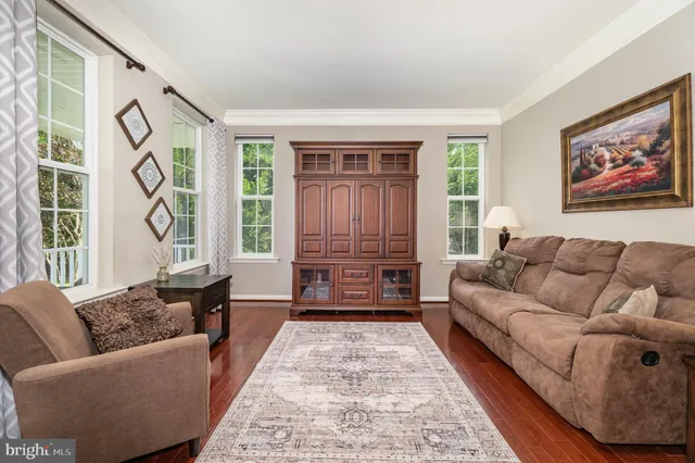 a dining room with furniture a window and wooden floor