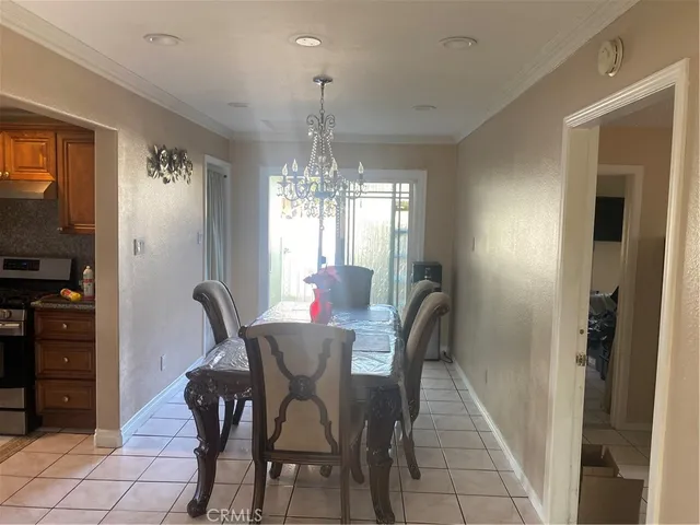 a view of a dining room with furniture and chandelier