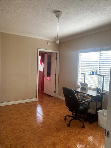 a view of a livingroom with workspace and a window