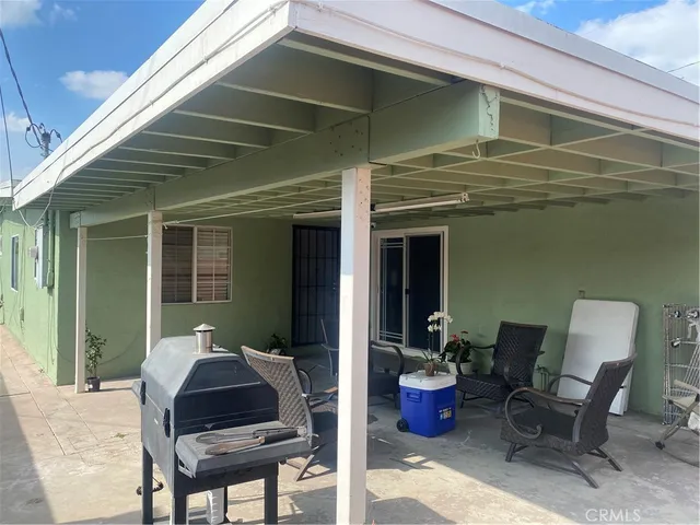 a front view of a house with outdoor seating