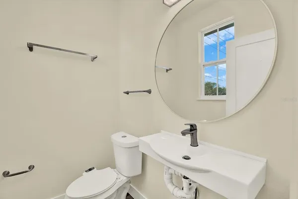 a bedroom with a bed and a potted plant