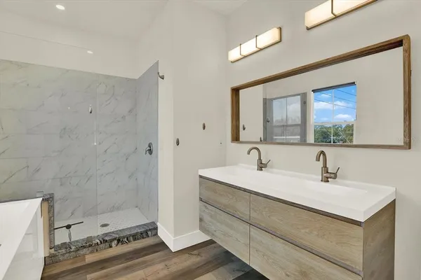 a bathroom with a bathtub and a window
