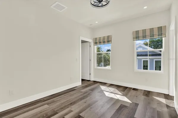 a view of an empty room and wooden floor