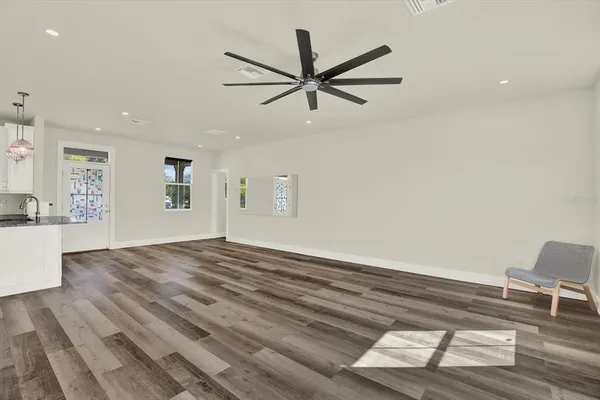 a living room with furniture a flat screen tv and a large window