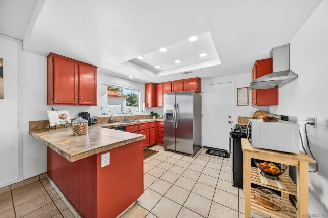 a kitchen with stainless steel appliances granite countertop a sink counter space and a window