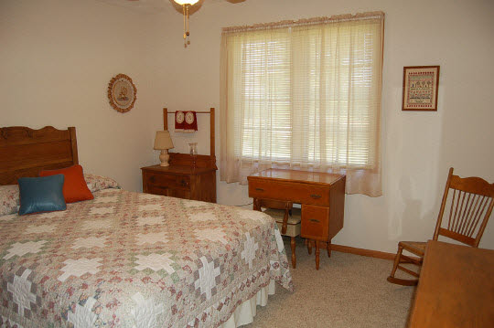 1771 East Town Line Road Oregon, IL 61061 - Photo 6 of 6 a bedroom with a bed and dresser with mirror