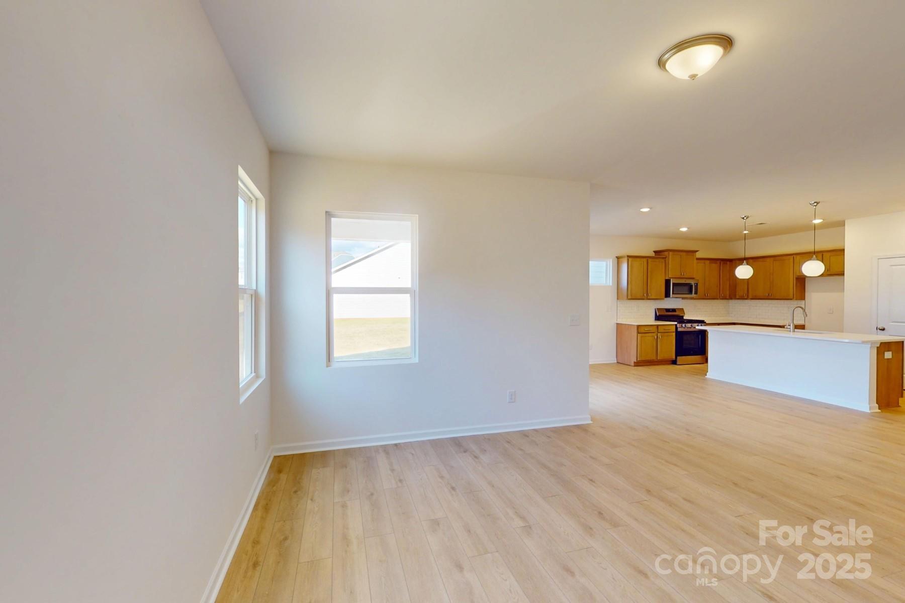 1494 Kate Cecil Way York, SC 29745 - Photo 12 of 20 an empty room with a kitchen and a sink