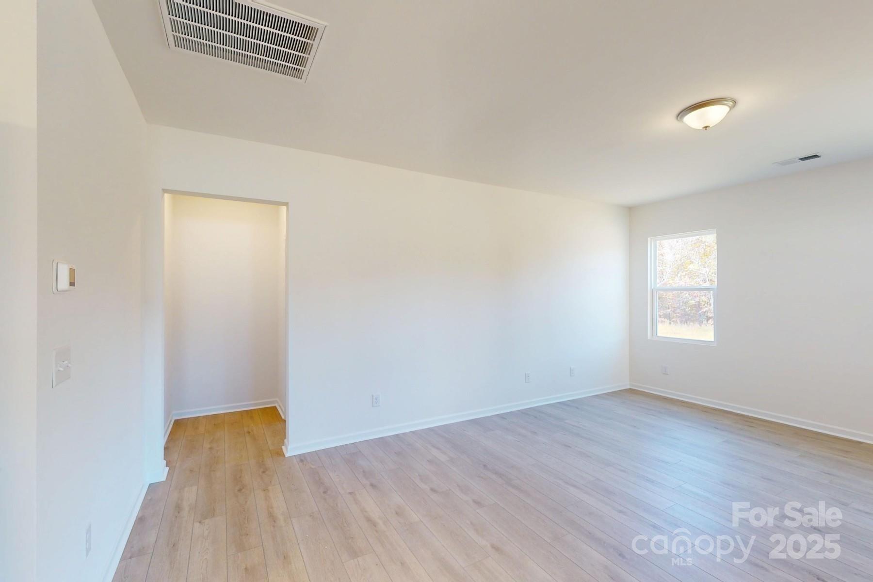 1494 Kate Cecil Way York, SC 29745 - Photo 13 of 20 an empty room with wooden floor and windows