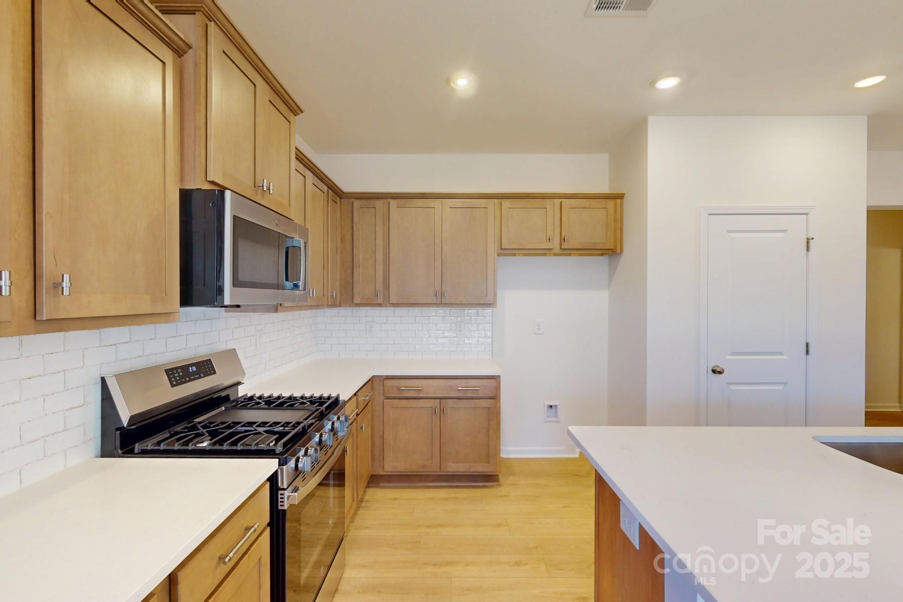 1494 Kate Cecil Way York, SC 29745 - Photo 7 of 20 a kitchen with a stove and a refrigerator