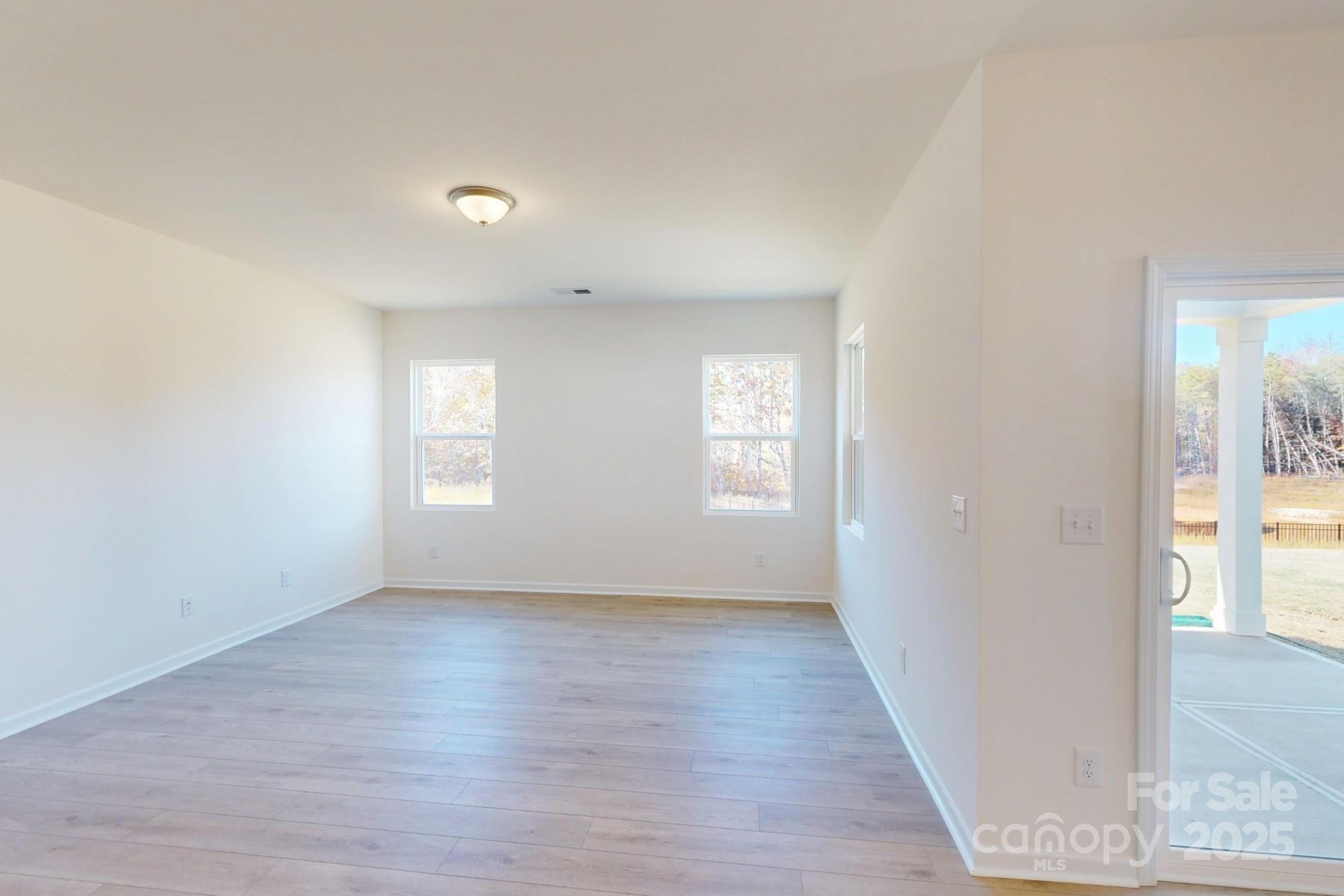 1494 Kate Cecil Way York, SC 29745 - Photo 10 of 20 an empty room with wooden floor and windows