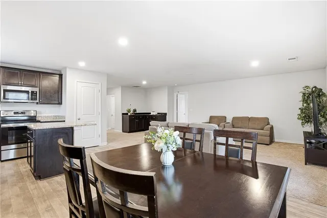 a view of a dining room with furniture and wooden floor