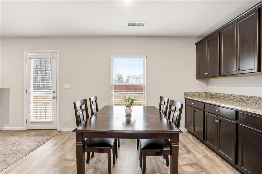 6968 New Dale Road Rex, GA 30273 - Photo 19 of 47 a view of a dining room with furniture and wooden floor
